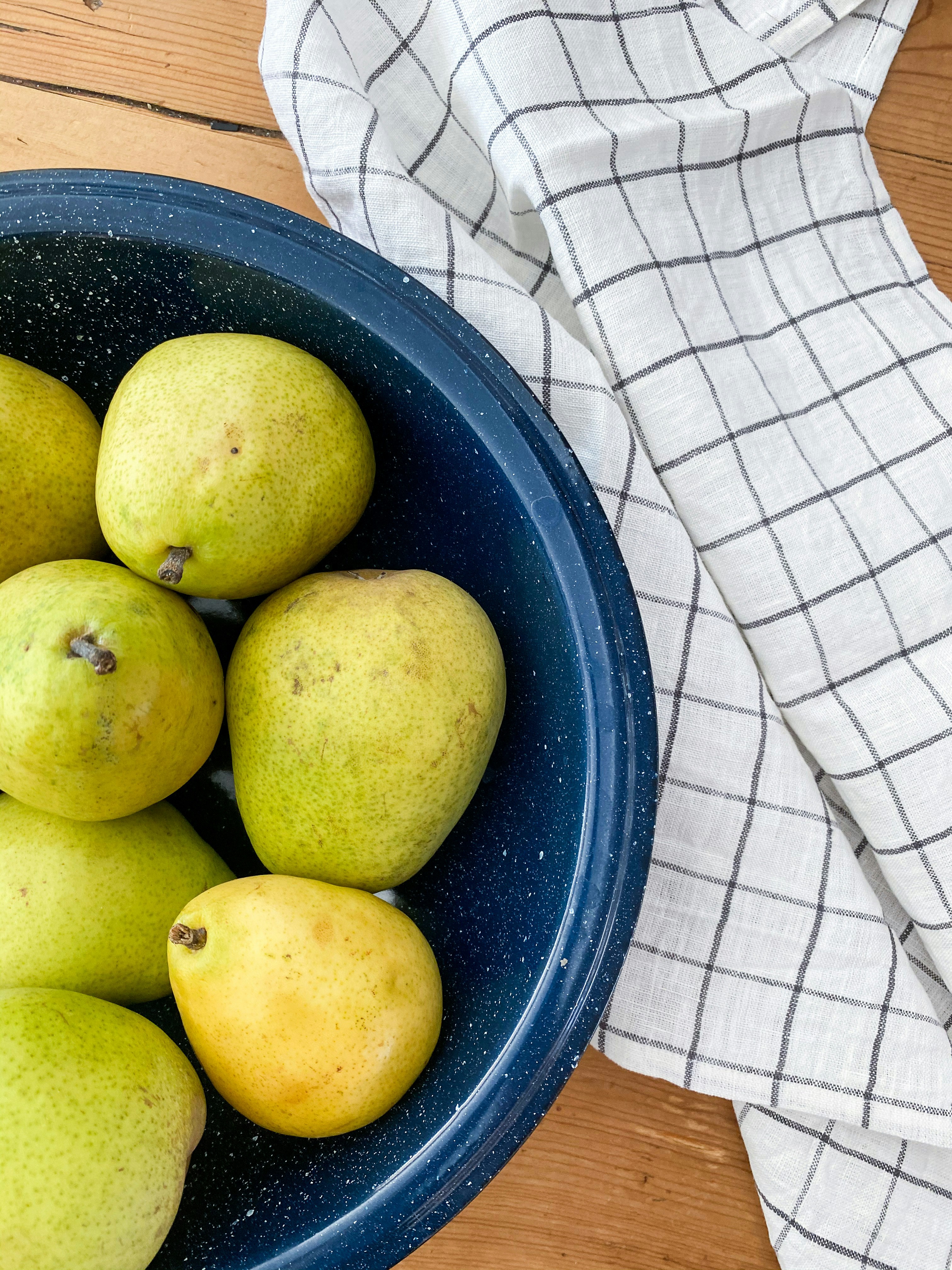 yellow round fruits on blue plastic container